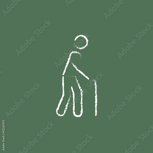 Man with cane icon drawn in chalk.