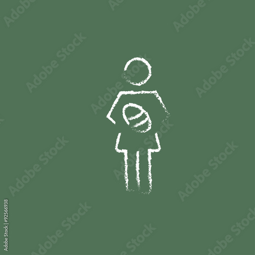Woman holding the baby icon drawn in chalk.