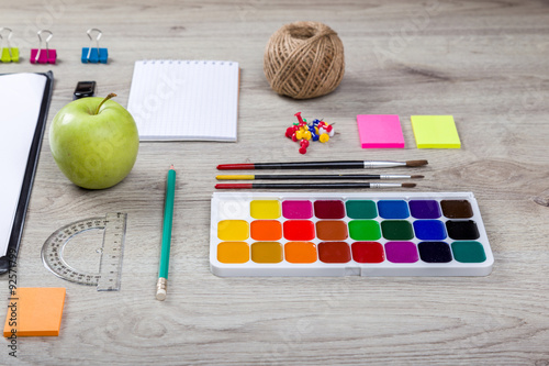 school supplies with pencils, paint, and rulers 