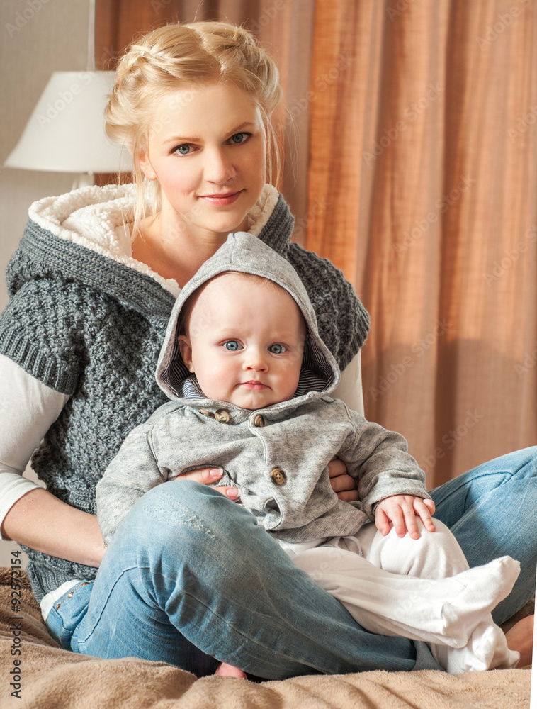 Mother and baby playing and smiling. Happy family.Home interior. Mother and baby playing and smiling. Happy family.Home interior.