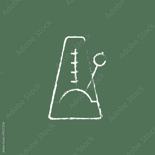 Metronome icon drawn in chalk.