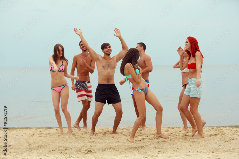 Beautiful young people having fun on beach