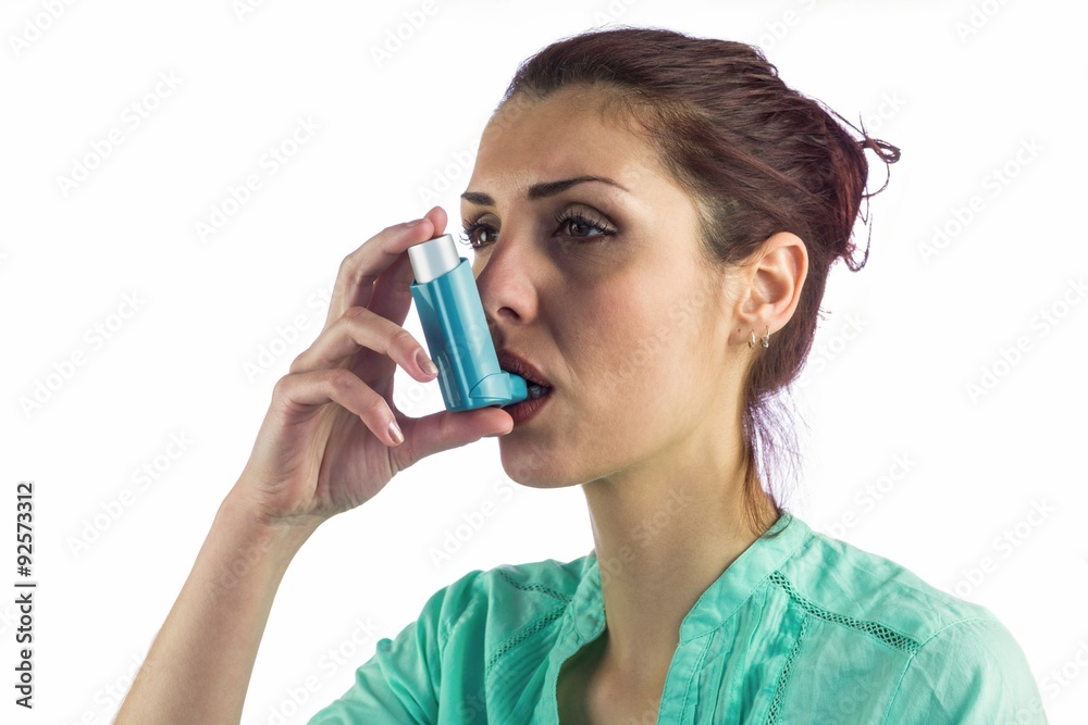 Close-up of woman using asthma inhaler  - obrazy, fototapety, plakaty 