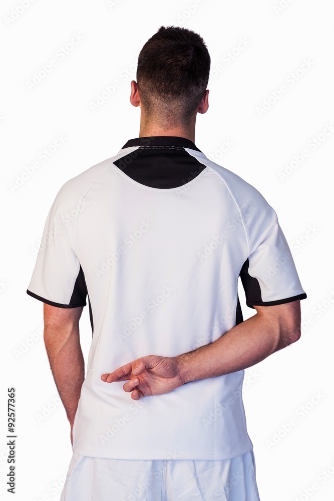 Rear view of rugby player with fingers crossed Rear view of rugby player with fingers crossed