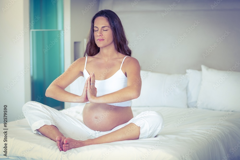Pregnant woman doing yoga Pregnant woman doing yoga