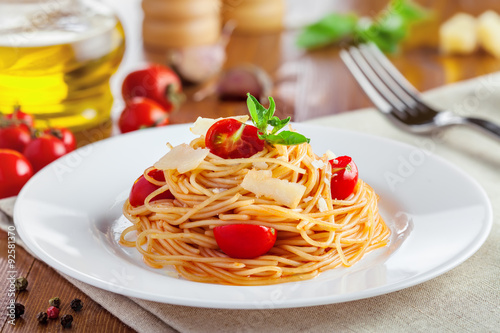 Spaghetti with tomato sauce, parmesan cheese and basil, delicious Italian food