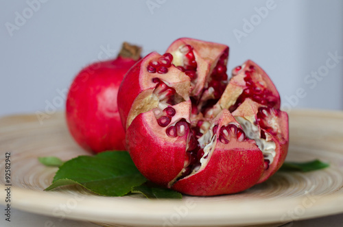 ripe pomegranate on a wooden plate