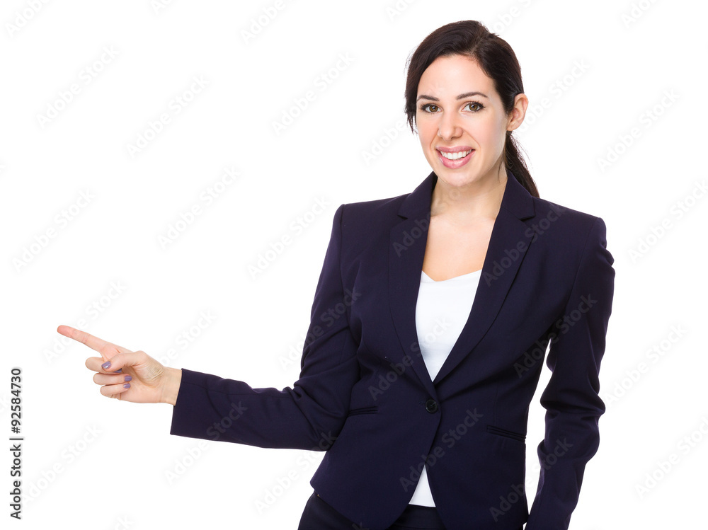 Brunette businesswoman with finger point aside Brunette businesswoman with finger point aside