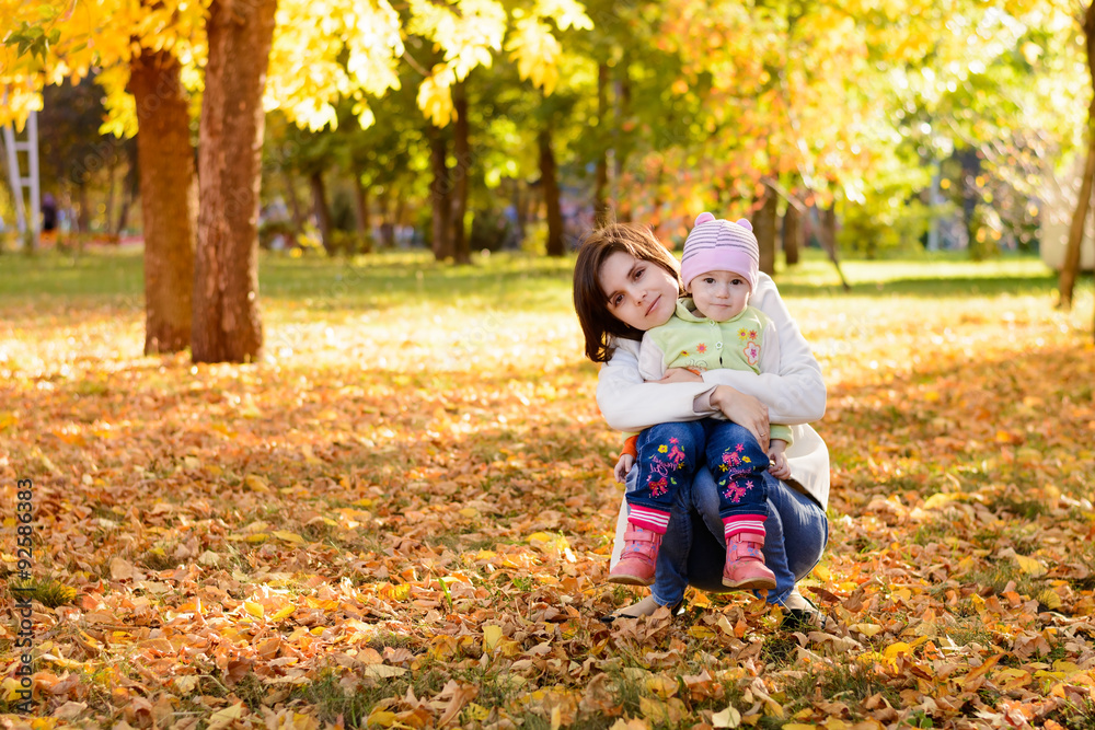 Mother with a baby hugging in the park Mother with a baby hugging in the park