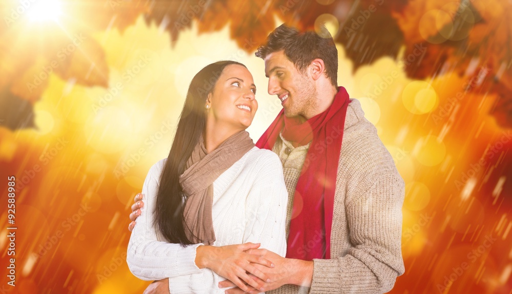 Composite image of young couple smiling and hugging Composite image of young couple smiling and hugging