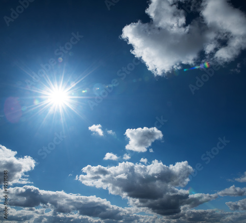 Blue sky with clouds and sun. © Tryfonov