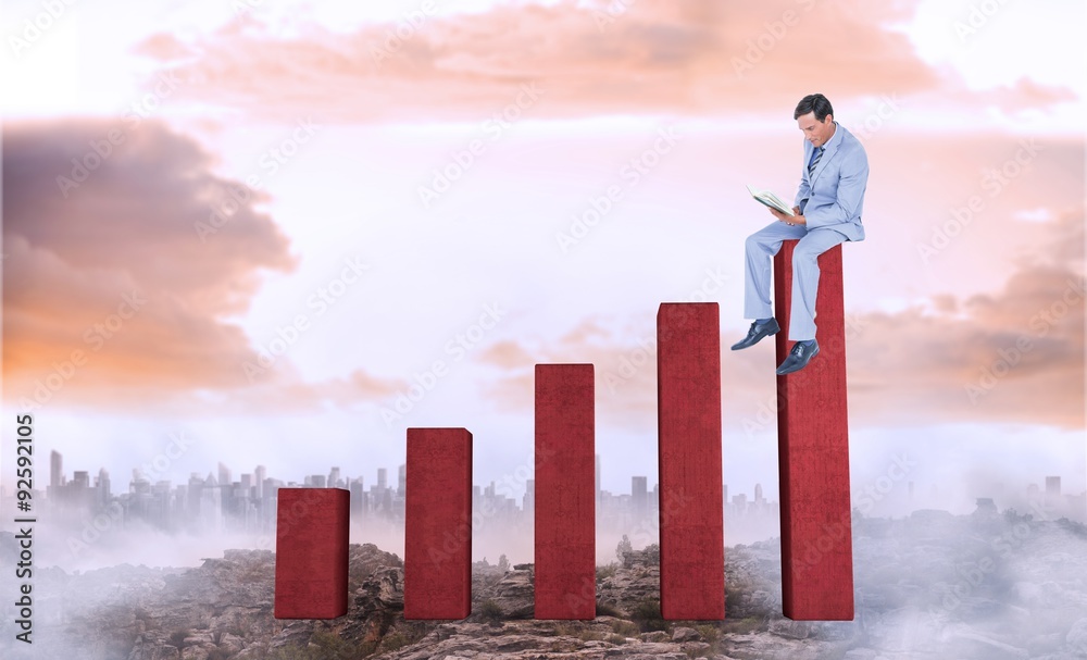 Composite image of businessman reading book while sitting Composite image of businessman reading book while sitting