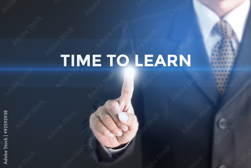 A Businessman holding a white sign with the message Time to Learn. Can bring to the medium of your ad. A Businessman holding a white sign with the message Time to Learn. Can bring to the medium of your ad.