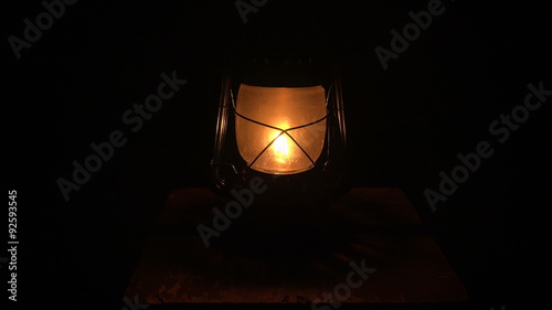 Oil lamp lit in the darkness. 4K.