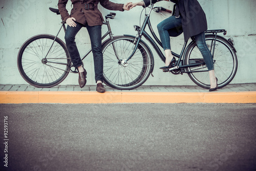 Fototapeta Naklejka Na Ścianę i Meble -  Young couple with a bicycle opposite city 