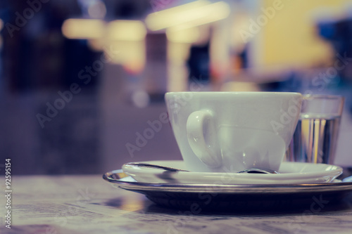 A cup of coffee on a tray on a table