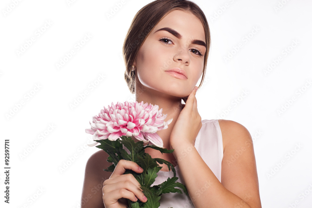 Young girl with chrysanthemum flower near face