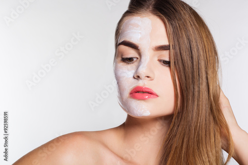 Beauty women getting clay facial mask, spa concept