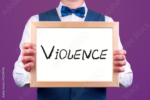 Canvas Print a man with a sign in his hand with the word violence