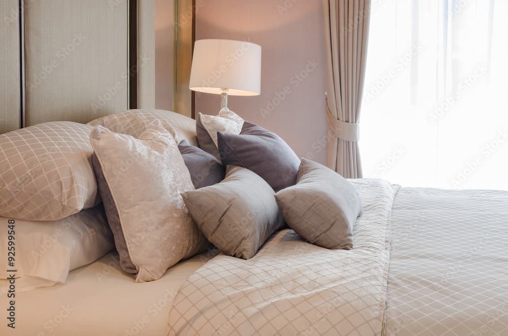 Fototapeta premium luxury bedroom with pillows on bed and white classic lamp