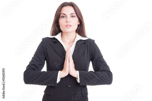 Attractive business woman praying isolated on white