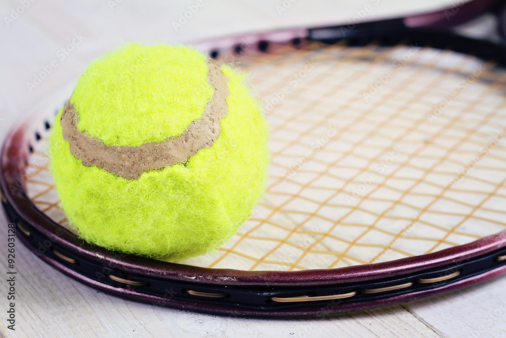 Close up on tennis racket and ball. Sport equipment background, wallpaper