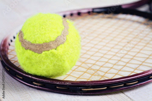 Close up on tennis racket and ball. Sport equipment background, wallpaper © dream@do