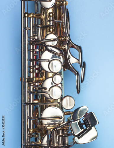 A saxophone on a clean blue background