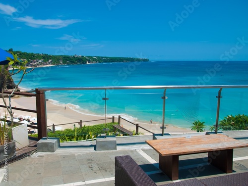 A table in the restaurant overlooking the blurred background of the sea. © avtk