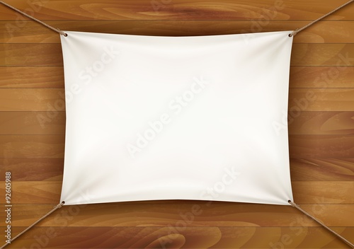 White cloth banner with text space on wooden background. Vector photo