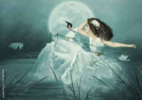 Obraz na plátně Young girl with long hair and swan in the river at night in the moonlight