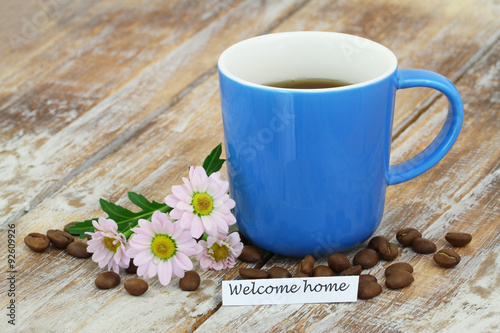 Welcome home card with mug of coffee and pink daisies 