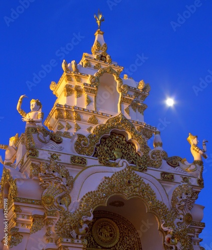 Gateway tower

The full moon shines brightly above this beautifully adorned entrance gateway tower at wat chedi luang, a popular temple with foreign tourists in the city of Chiang Mai, Thailand.