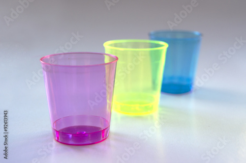 Fluorine, pink, blue and green colored cups photo