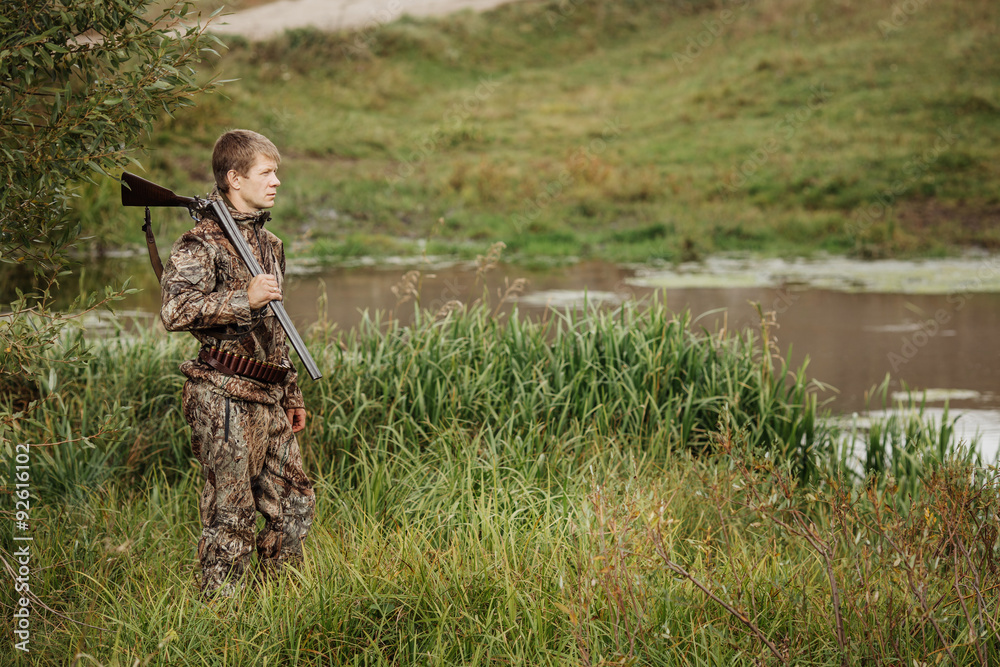 hunter in camouflage clothes ready to hunt with hunting rifle hunter in camouflage clothes ready to hunt with hunting rifle