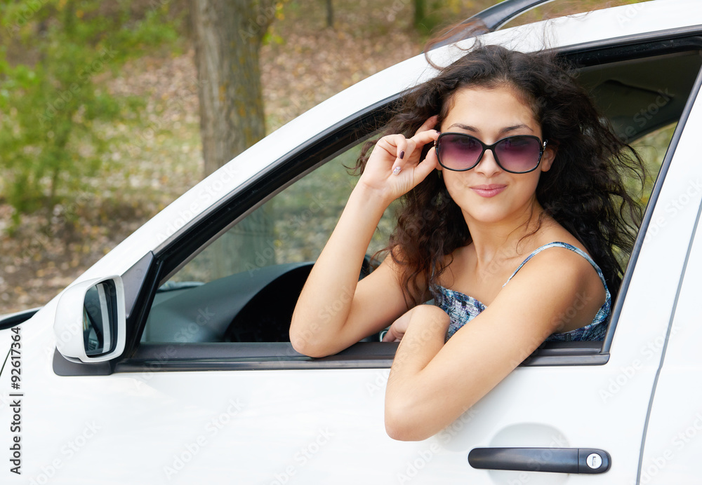 girl driver portrait with sunglasses inside car