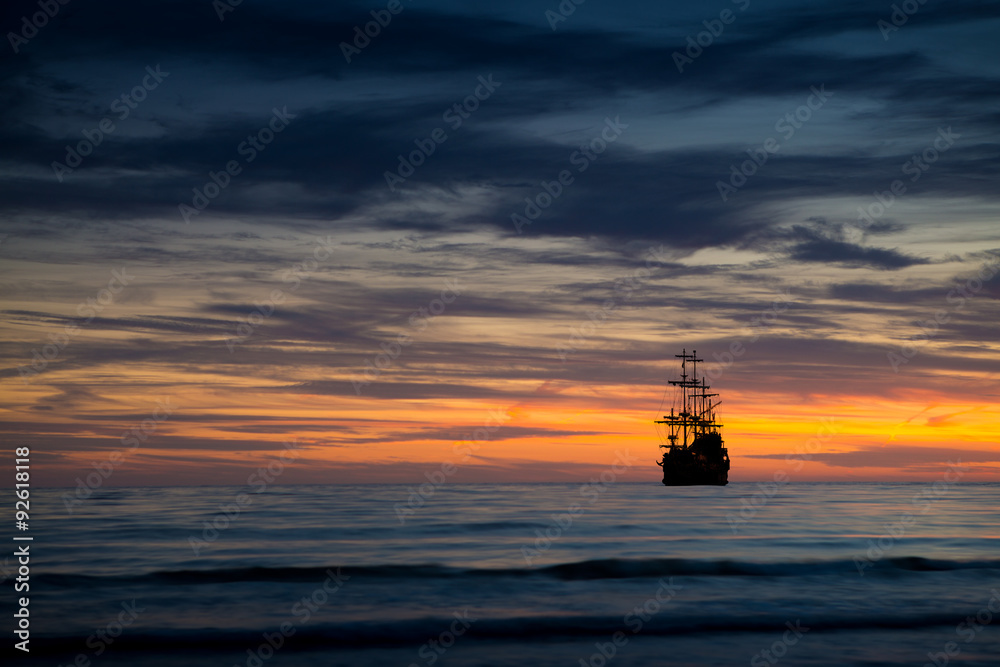 Pirate ship in sunset scenery. Stock Photo | Adobe Stock