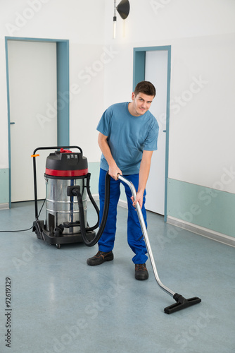 Male Worker With Vacuum Cleaner