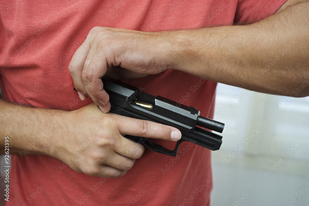 Man load a gun pistol Man load a gun pistol