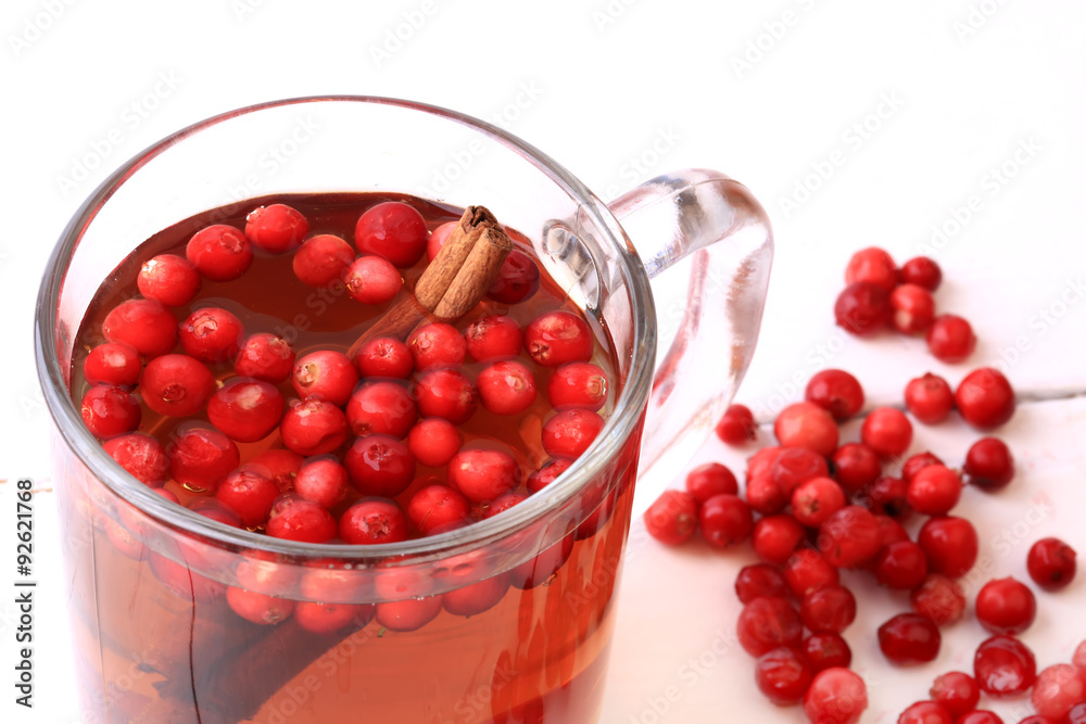 tea with cranberry and cinnamon on a white wooden background Christmas tea with cranberry and cinnamon on a white wooden background Christmas