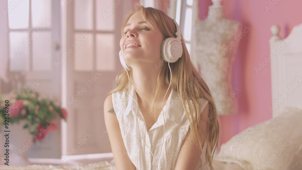 Young beautiful woman enjoying the music in headphones Young beautiful woman enjoying the music in headphones