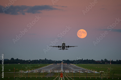 Plane take-off under the full moon