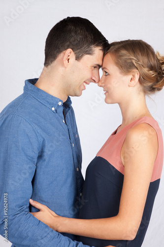 Romantic couple touching foreheads together and smiling