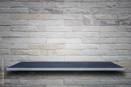 Empty top of natural stone shelves and stone wall background
