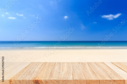 Empty top of wooden table and view of tropical beach