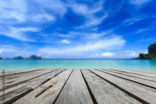 Top of wood table and view of sea and blue sky