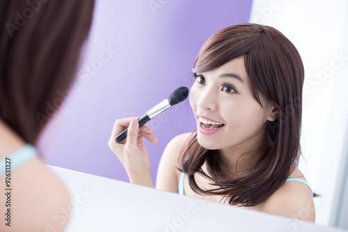 Smile woman with makeup brushes