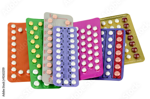 Colorful oral contraceptive pill strips isolated on white background.