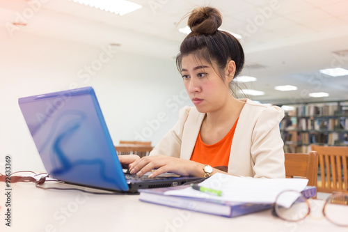 working woman typing a keyboard laptop computer