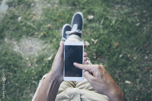 Young man with mobile phone...